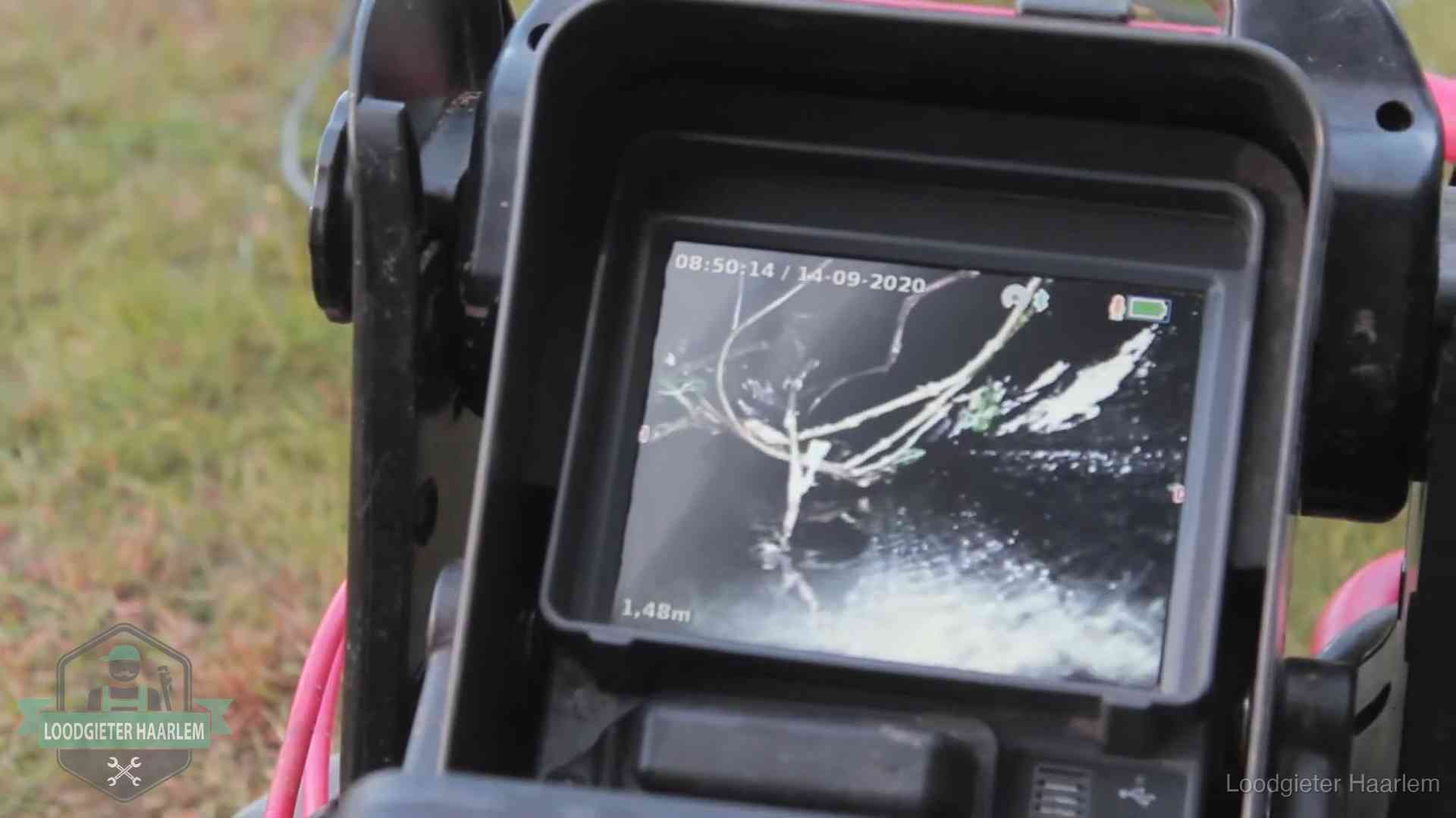 Camera-inspectie van het riool in Haarlem Monitor van een rioolcamera toont wortelingroei in de rioolbuis bij een woning in Haarlem