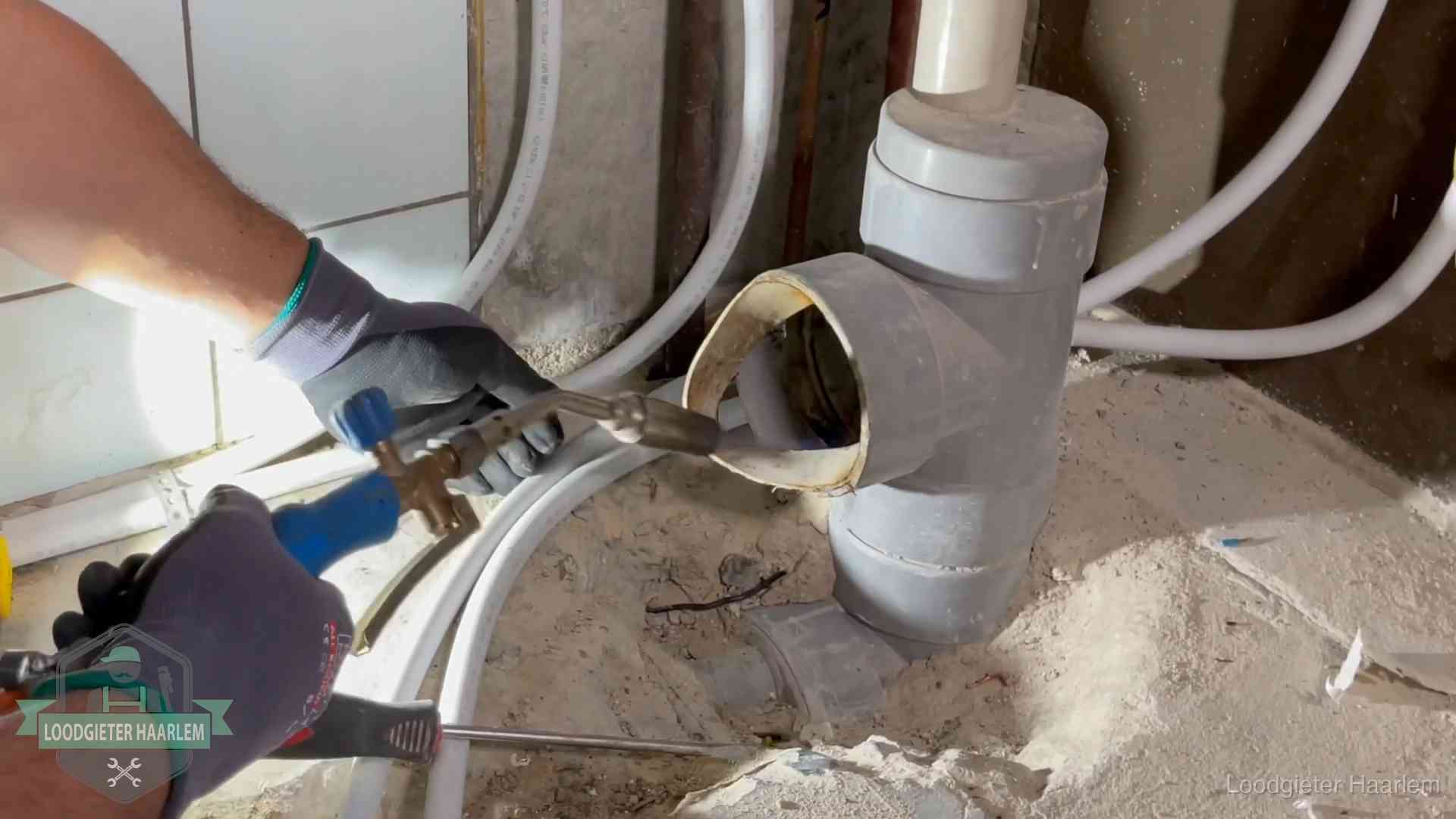 Vakmanschap van onze loodgieters in Haarlem Loodgieter werkt met brander en messing kraanwerk aan leidingen in Haarlem